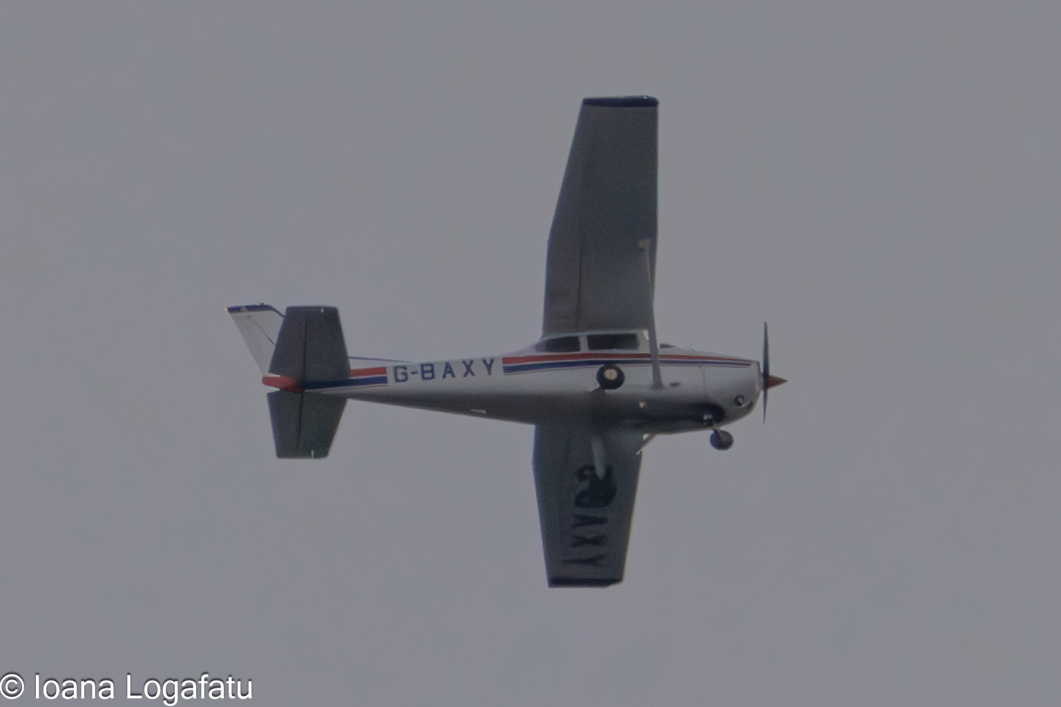 Vintage aircraft soaring through the gray sky